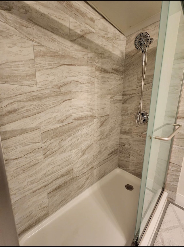 bathroom with a tile shower