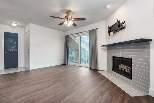 unfurnished living room with hardwood / wood-style flooring, a fireplace, and ceiling fan