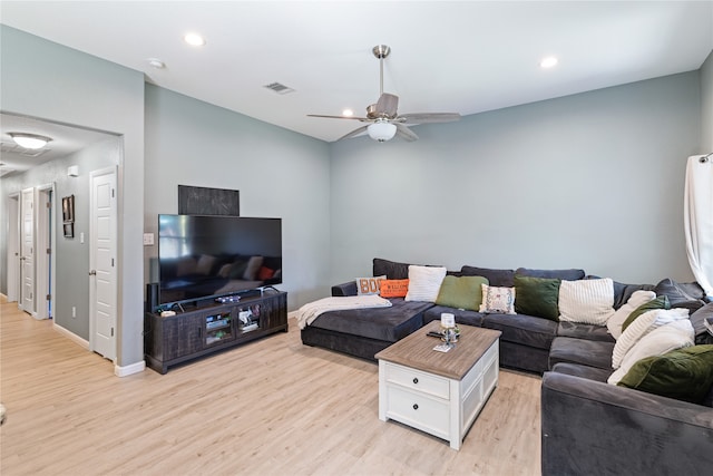 living room with light hardwood / wood-style flooring and ceiling fan