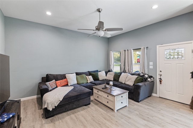 living room with light hardwood / wood-style floors and ceiling fan