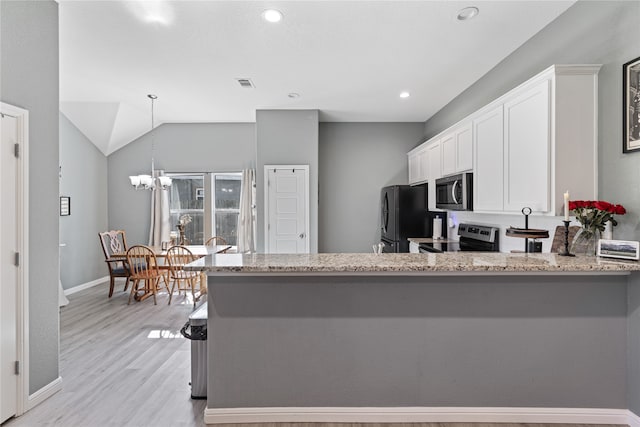 kitchen featuring light hardwood / wood-style flooring, kitchen peninsula, decorative light fixtures, white cabinetry, and appliances with stainless steel finishes