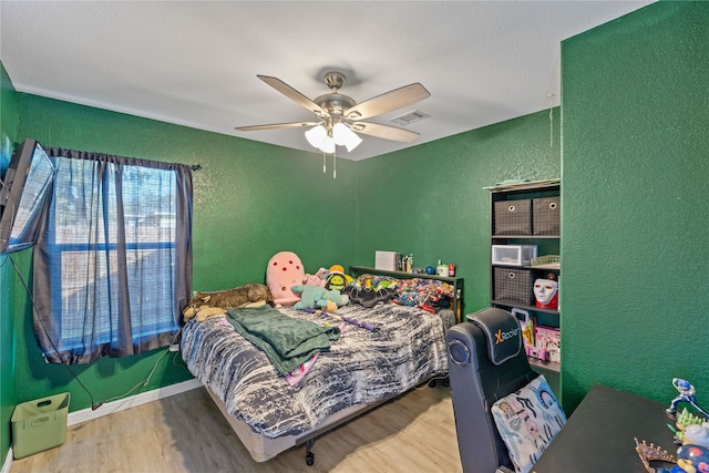 bedroom featuring wood-type flooring and ceiling fan