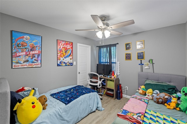 bedroom with ceiling fan and light hardwood / wood-style flooring