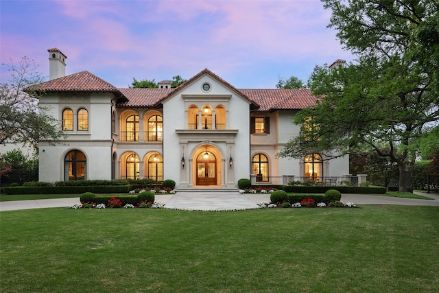 mediterranean / spanish-style house featuring a lawn