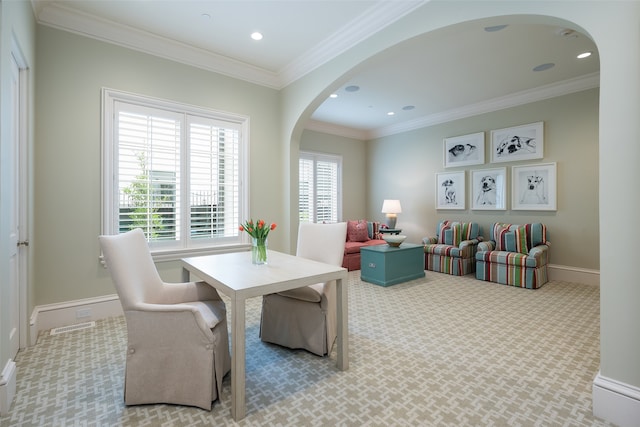 carpeted dining room featuring ornamental molding