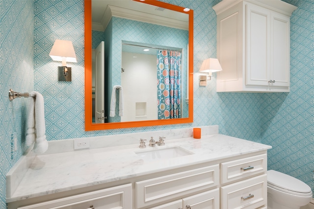 bathroom with vanity, ornamental molding, and toilet