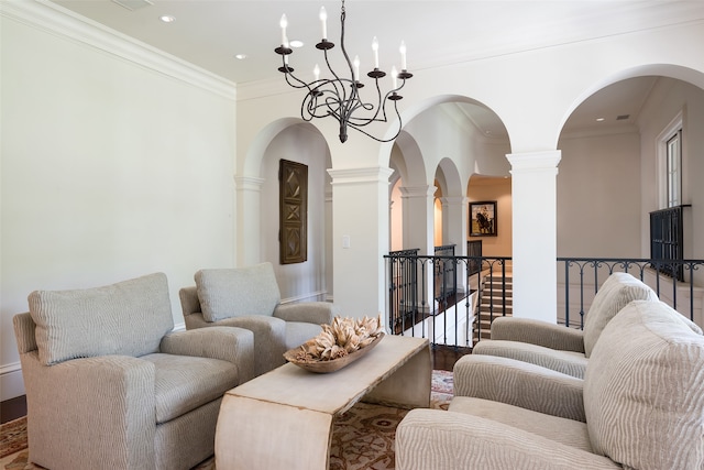 living room with ornamental molding, decorative columns, and wood-type flooring