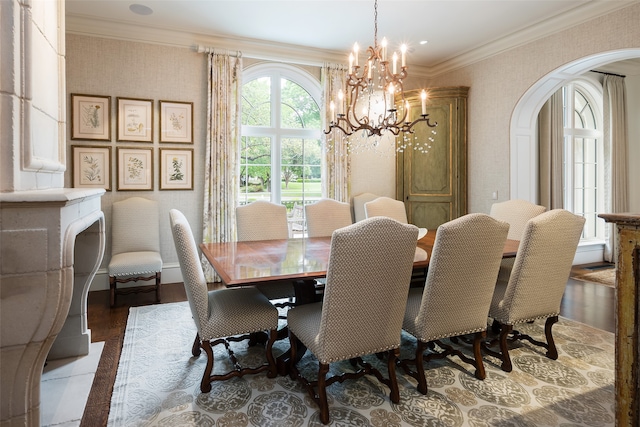 dining space with a notable chandelier, ornamental molding, and hardwood / wood-style floors