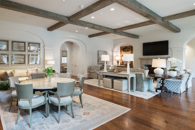 dining room featuring beam ceiling, coffered ceiling, and hardwood / wood-style flooring