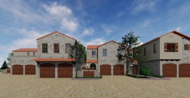 mediterranean / spanish home featuring a garage