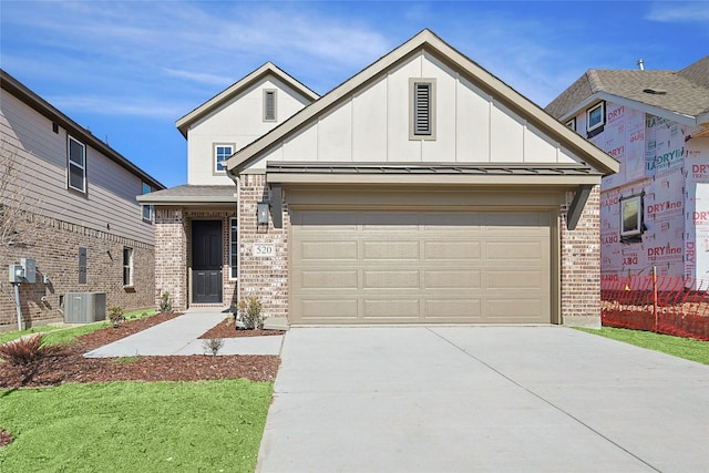 view of front of property with cooling unit and a garage