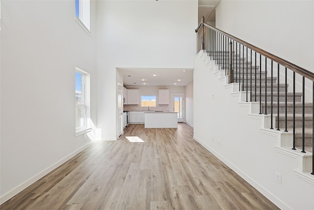 entryway featuring light hardwood / wood-style flooring and a high ceiling