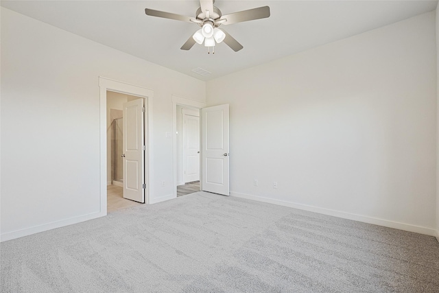 carpeted spare room with ceiling fan