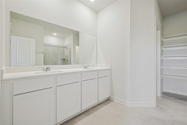 bathroom featuring vanity, tile patterned floors, and a shower with door