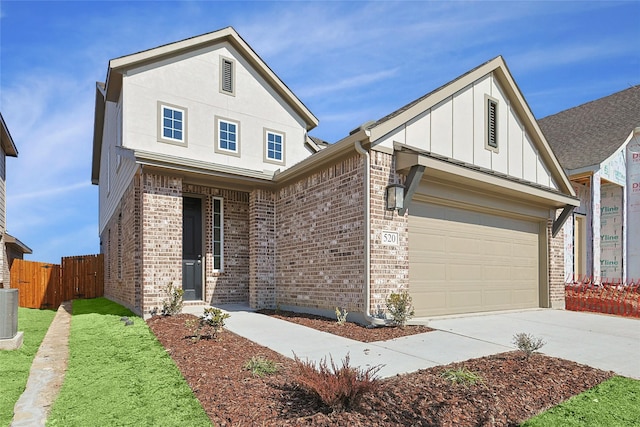 view of front facade featuring cooling unit and a garage