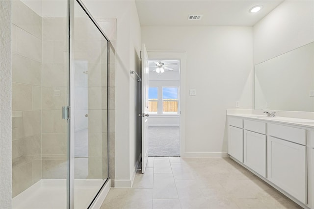 bathroom with an enclosed shower, vanity, and tile patterned floors