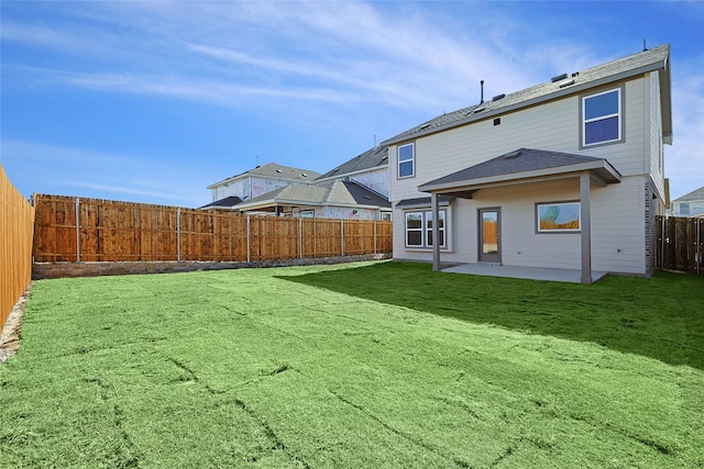 back of property featuring a yard and a patio area