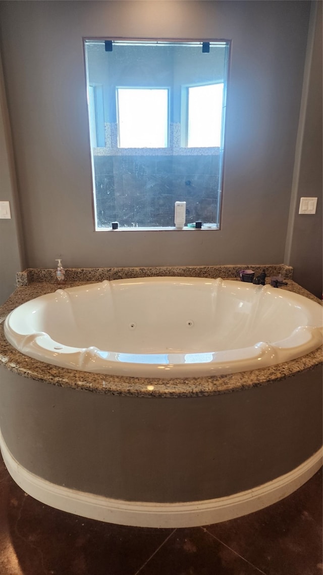 bathroom featuring a tub to relax in and tile patterned floors