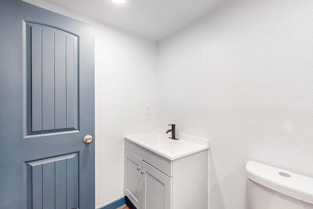 bathroom featuring toilet and vanity