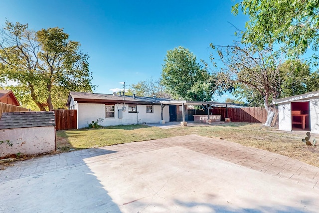 back of property featuring a yard and a patio