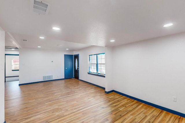 unfurnished room featuring light hardwood / wood-style flooring and a wealth of natural light