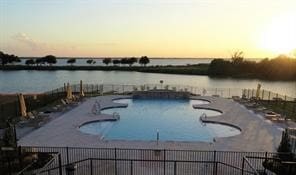 pool at dusk with a water view