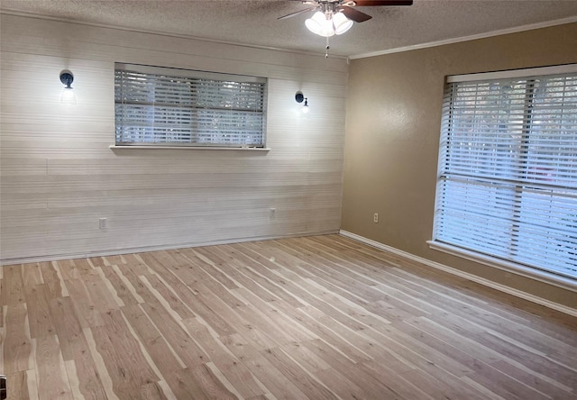 unfurnished room with light wood-type flooring, ceiling fan, and a textured ceiling