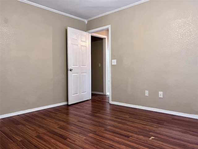 empty room with crown molding and dark wood-type flooring