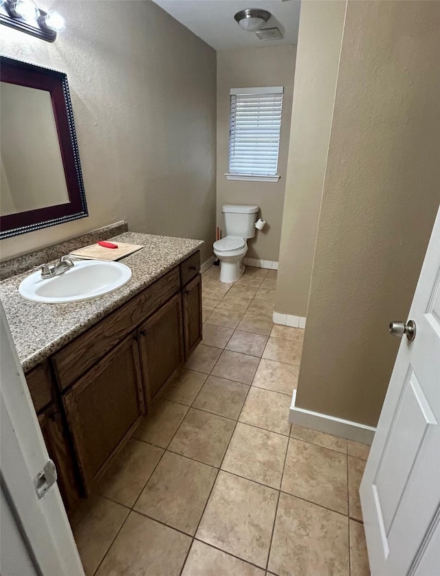 bathroom featuring vanity, toilet, and tile patterned floors