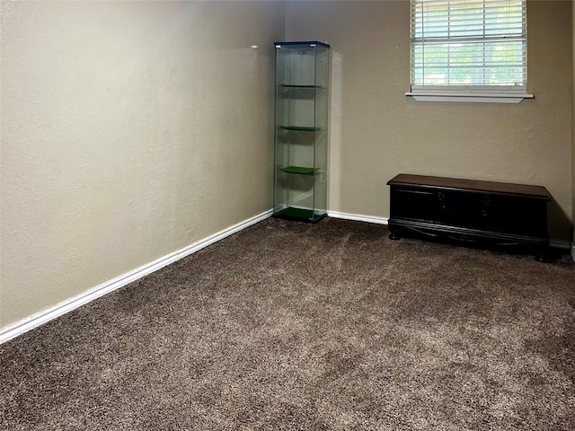 unfurnished bedroom with dark colored carpet