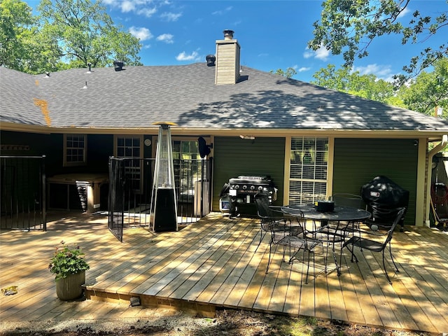 wooden deck with a grill