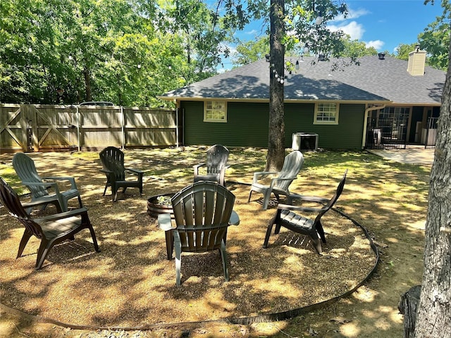 view of yard featuring central AC unit and a fire pit