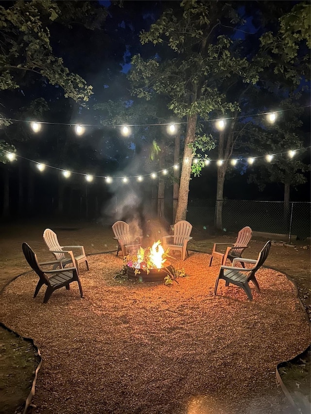 yard at night featuring an outdoor fire pit