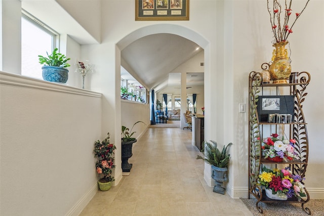 hallway featuring light tile patterned floors and a wealth of natural light