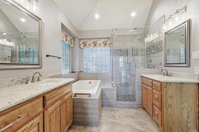 bathroom with vanity, separate shower and tub, and vaulted ceiling