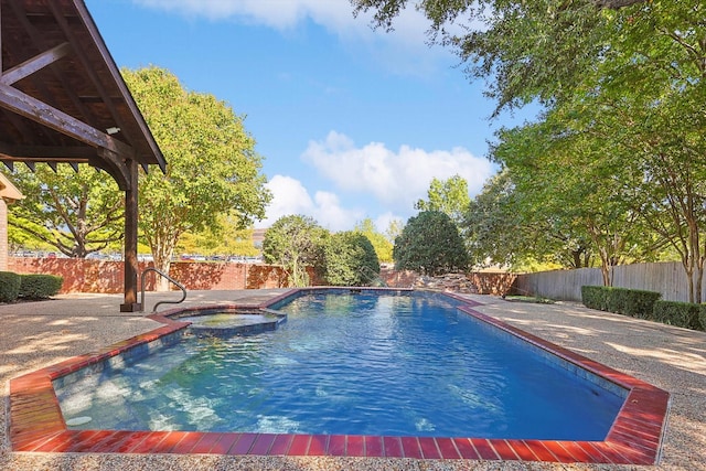 view of pool with an in ground hot tub