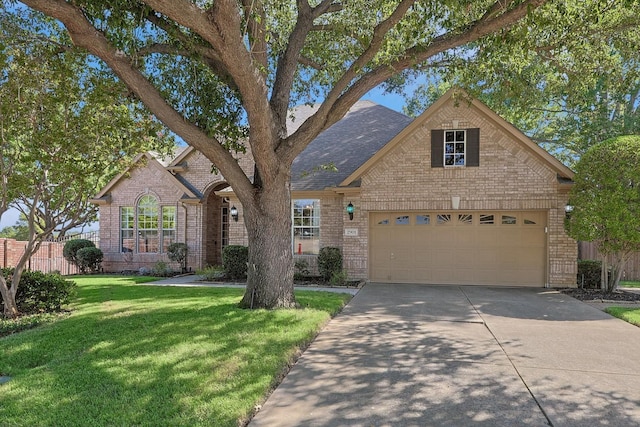 view of front of property with a garage and a front yard