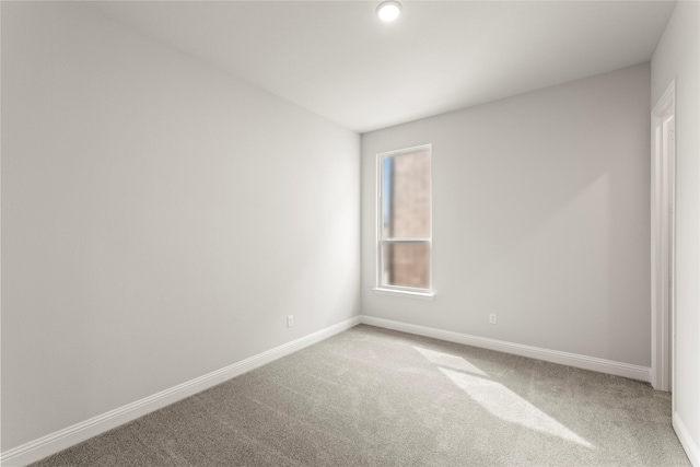 unfurnished room with baseboards and carpet floors