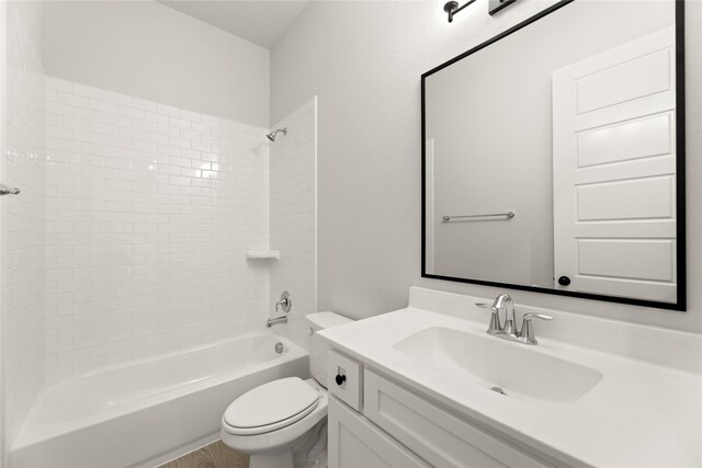 bathroom featuring toilet, vanity, and shower / washtub combination