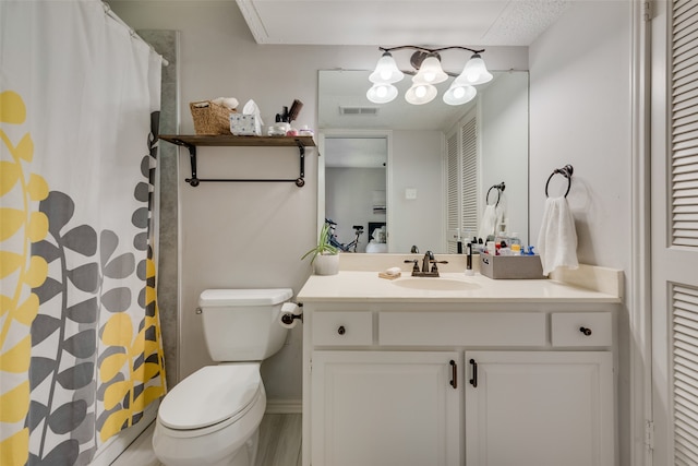 bathroom with vanity, toilet, and walk in shower