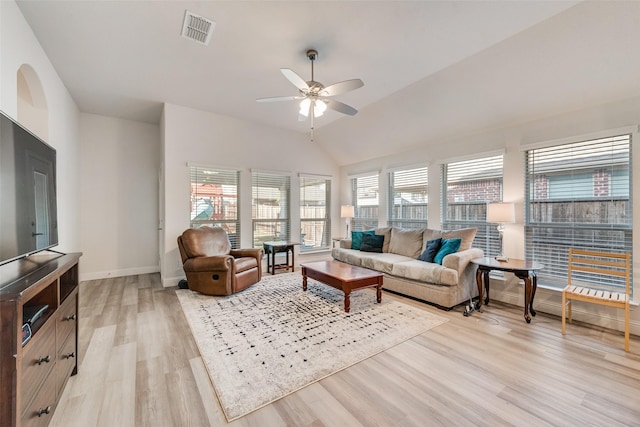 living room with ceiling fan, lofted ceiling, and light hardwood / wood-style flooring