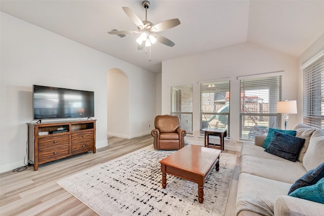 living room with light hardwood / wood-style flooring, ceiling fan, and vaulted ceiling