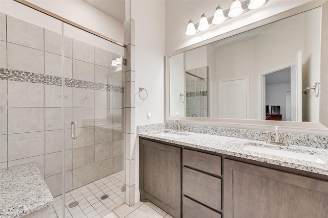 bathroom featuring vanity, tile patterned flooring, and a shower with shower door