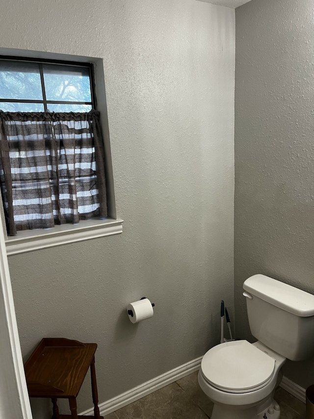 bathroom featuring tile patterned floors and toilet