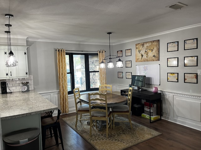 dining space featuring crown molding, a textured ceiling, and dark wood-type flooring