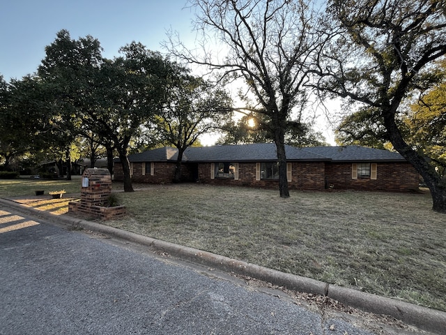 ranch-style house featuring a yard