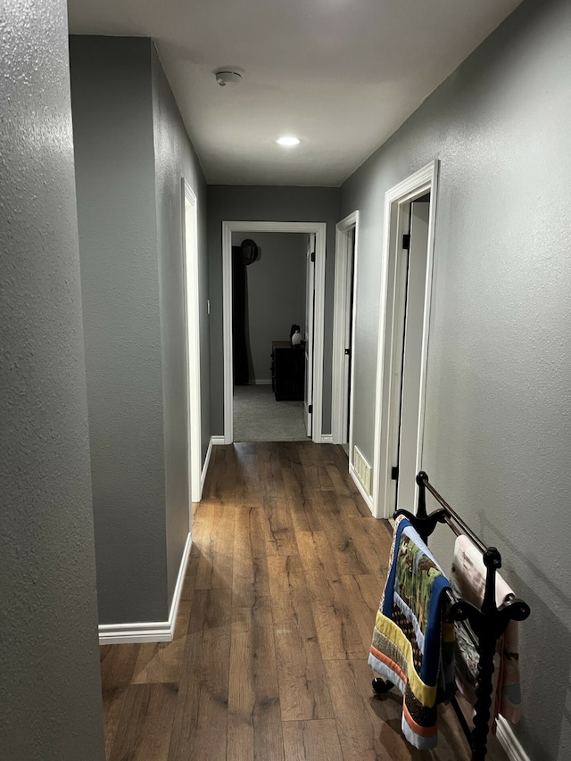 corridor with dark hardwood / wood-style floors