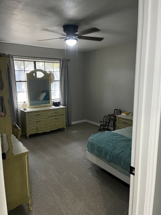 carpeted bedroom featuring a textured ceiling and ceiling fan