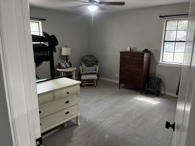 living area featuring carpet floors and ceiling fan