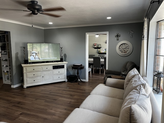 living room featuring ceiling fan, ornamental molding, a textured ceiling, and dark hardwood / wood-style floors